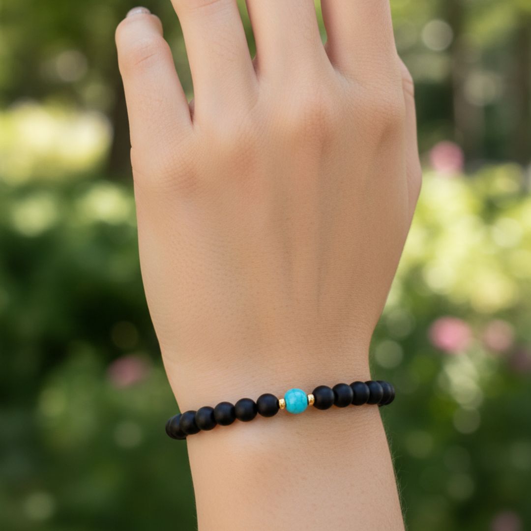 Woman wearing black turquoise beaded bracelet outdoors