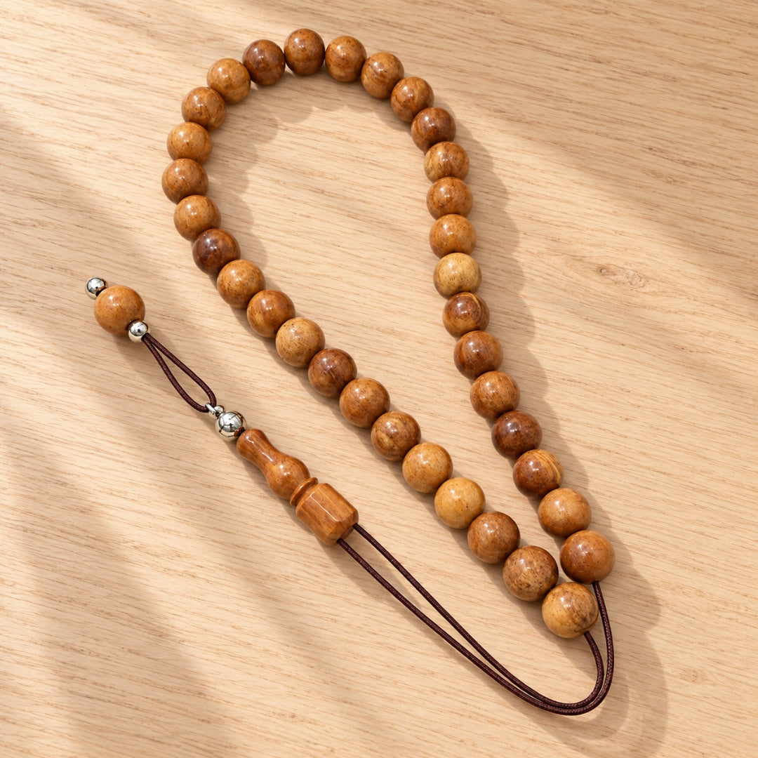 Round wooden beads on wood surface