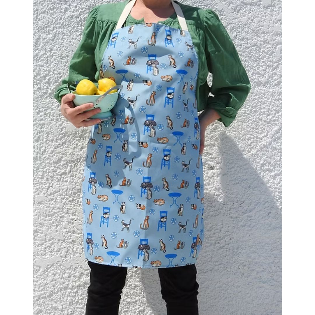 Greek Island Cats Apron – water-resistant apron with Greek cats, blue chairs and café tables on soft blue, worn, alternate view | Thalassea