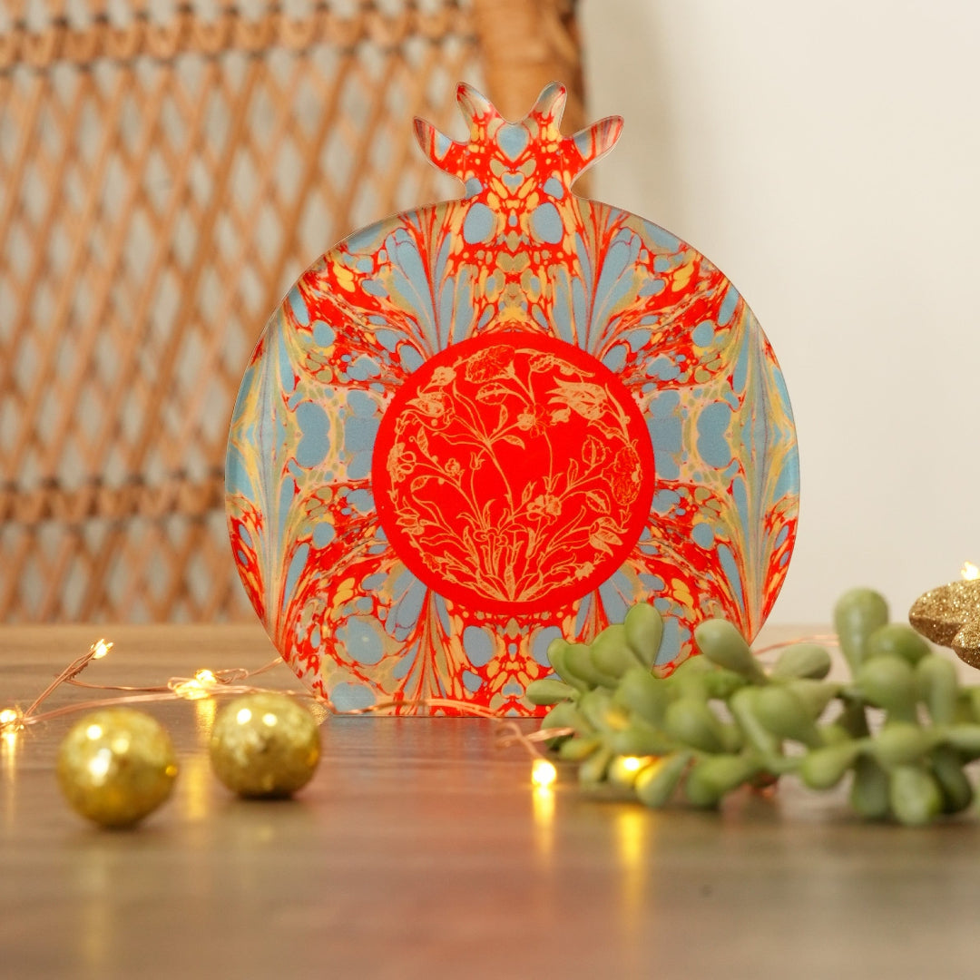 Decorative plate with intricate design on a wooden surface with decorative elements.