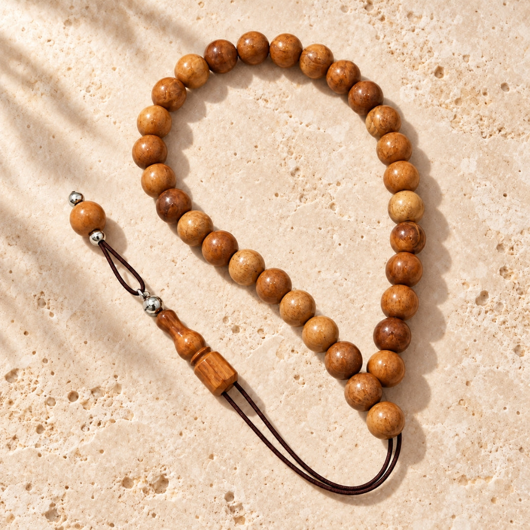 Round wooden beads on beige stone