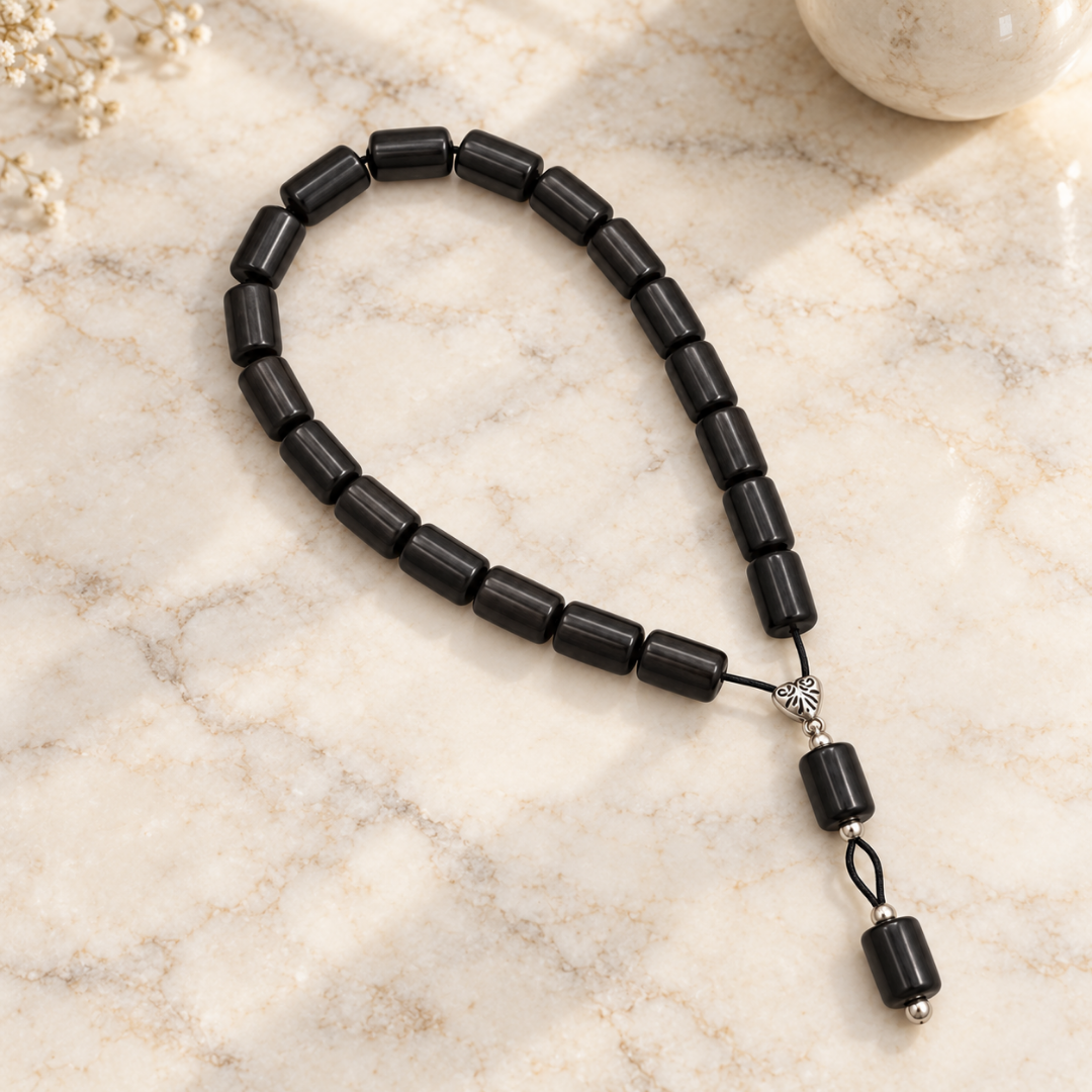 Black beaded strand on cream stone