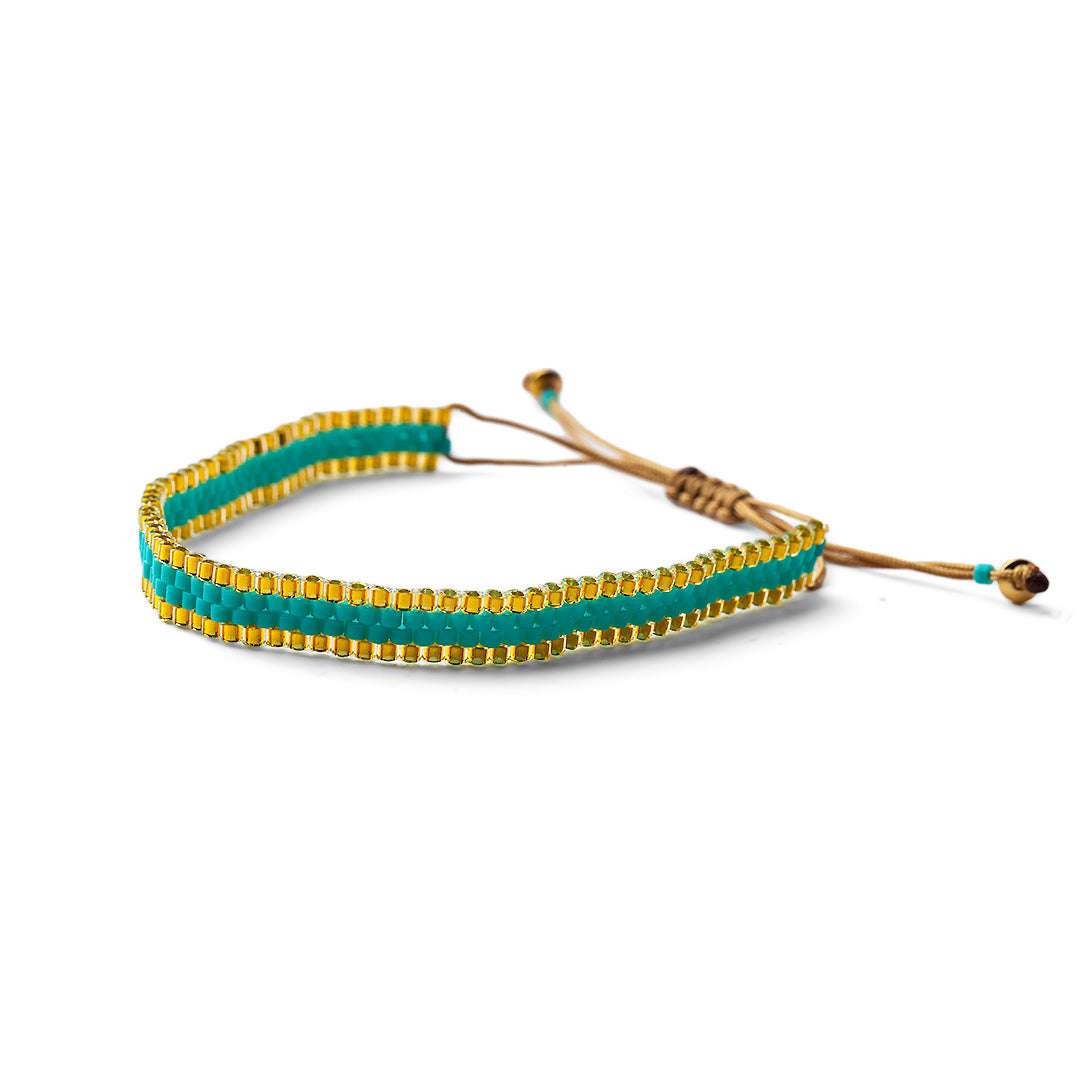 A gold-plated and turquoise beaded adjustable bracelet with a sliding closure.