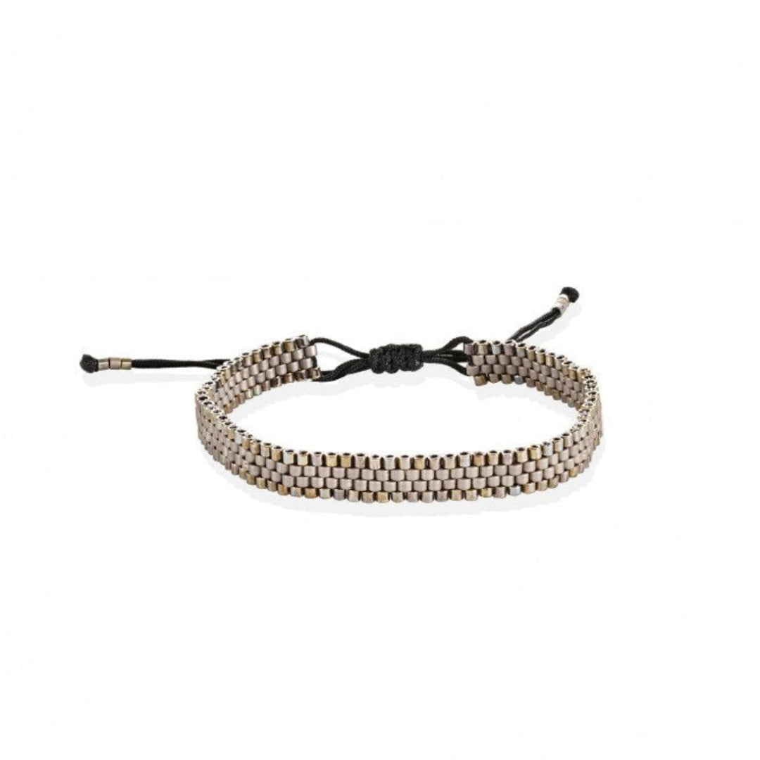An adjustable bracelet with gold-plated beads and a black cord, featuring a vintage-inspired aesthetic.