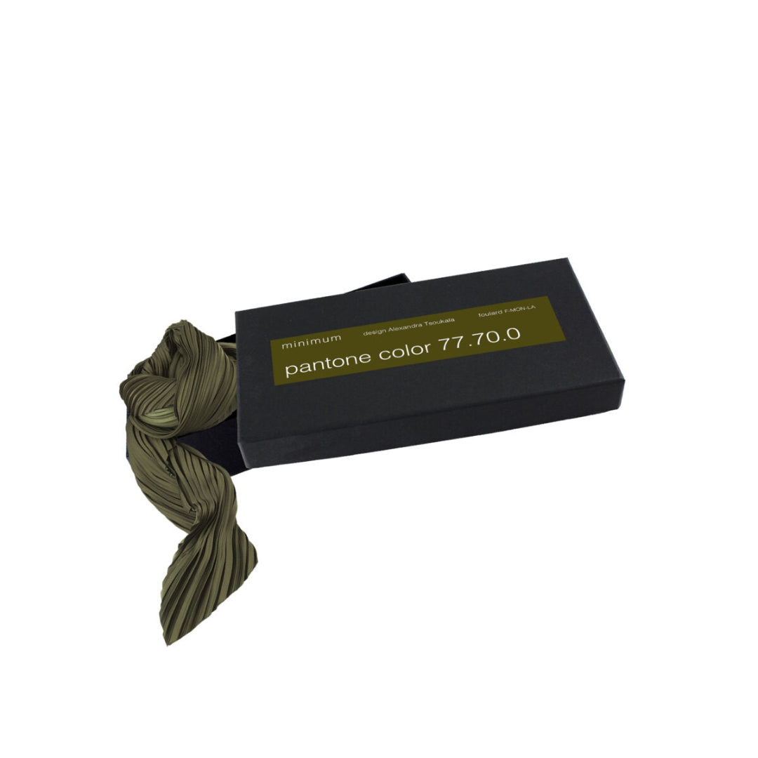 Green yarn with a black box labeled 'Pantone color 77.70.0' on a white background