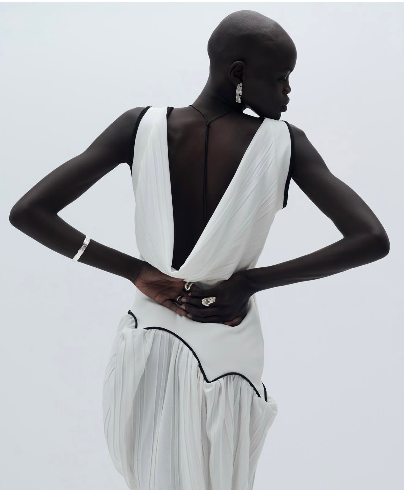 Woman wearing a white dress with a black background