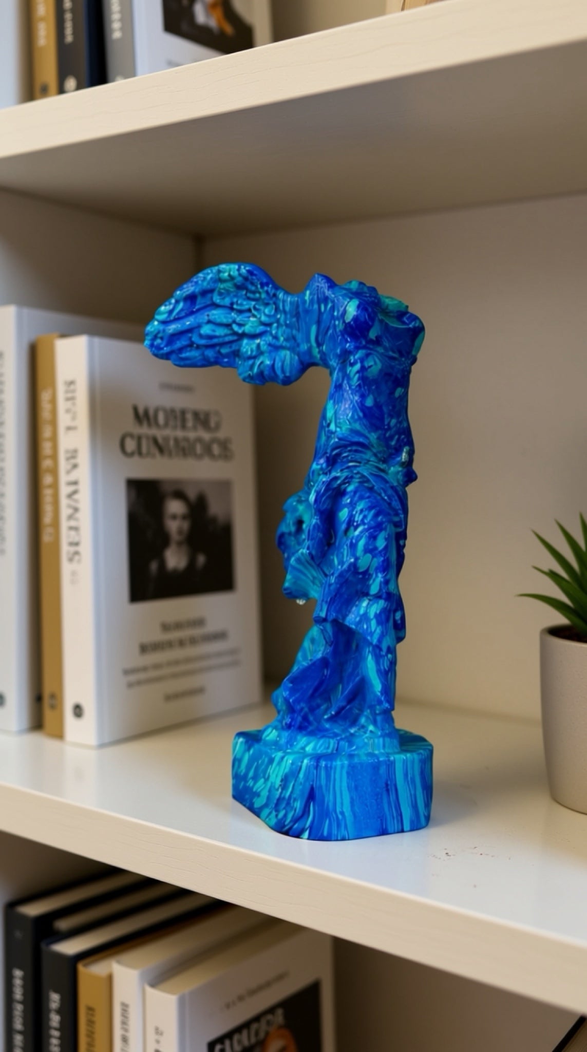 Winged Victory of Samothrace Statue Blue – handmade Greek Ebru-marbled statue in cobalt and turquoise, styled on a bookshelf | Thalassea