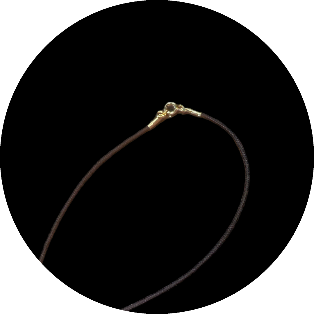 Gold necklace on a black background
