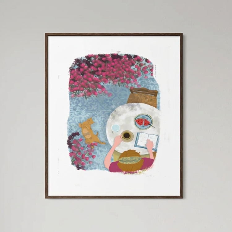 A framed art print featuring a whimsical illustration of an artist painting, displayed on a neutral wall above a console table in a styled living room setting.