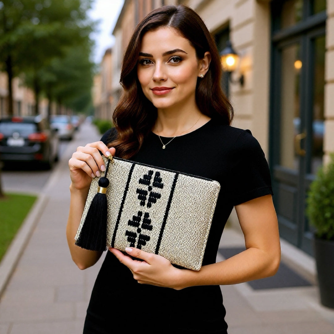 Woman holding a decorative clutch on a city street