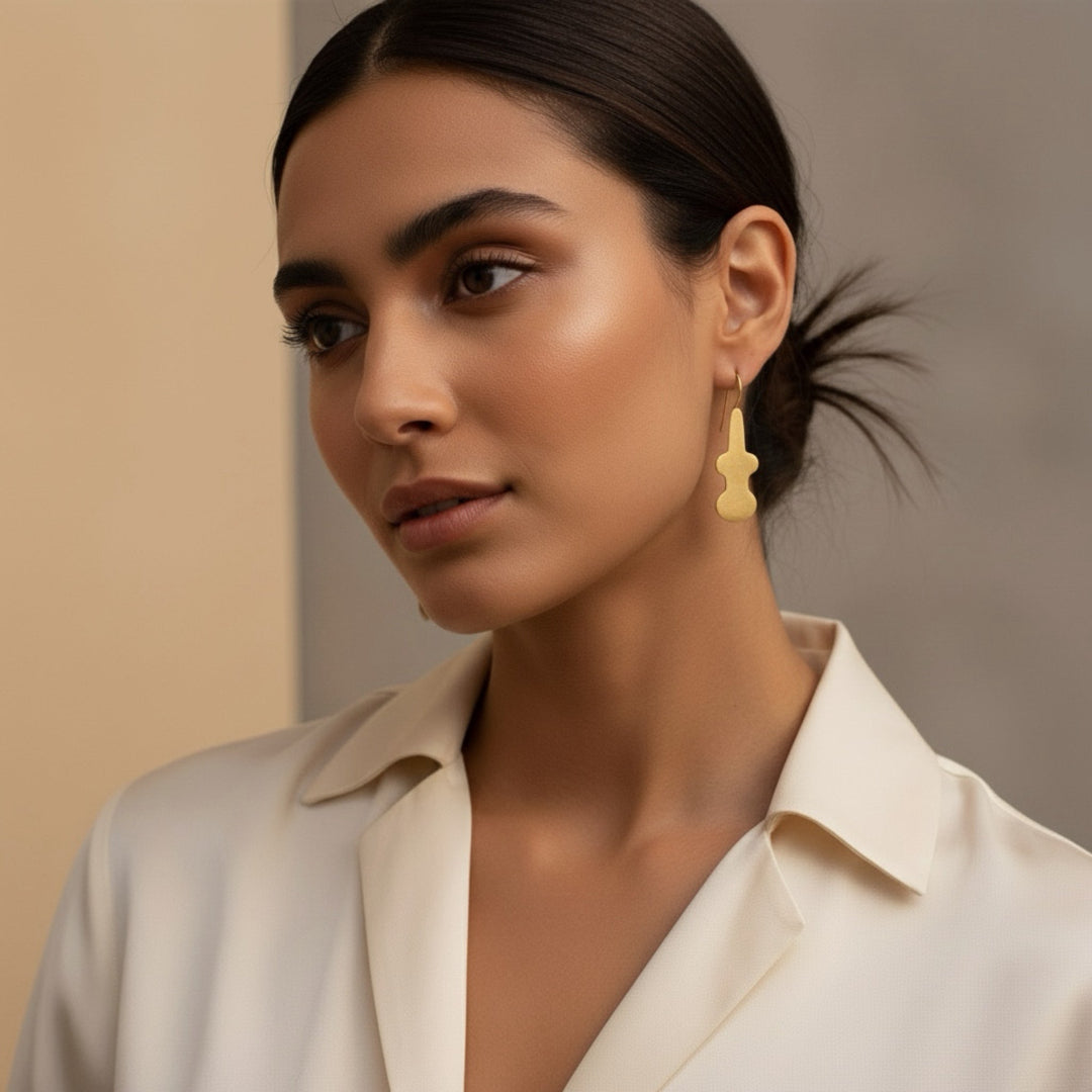 Woman wearing a beige outfit with a blurred background