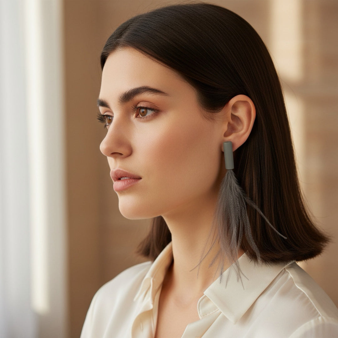 Close-up of a woman wearing feather earrings with a blurred background