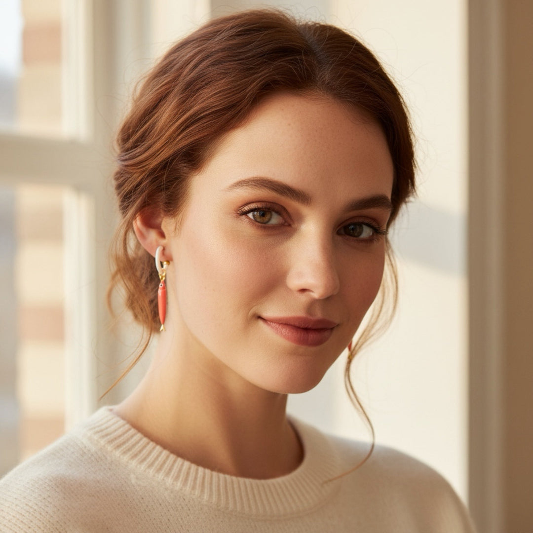 Woman wearing a beige sweater with a blurred indoor background