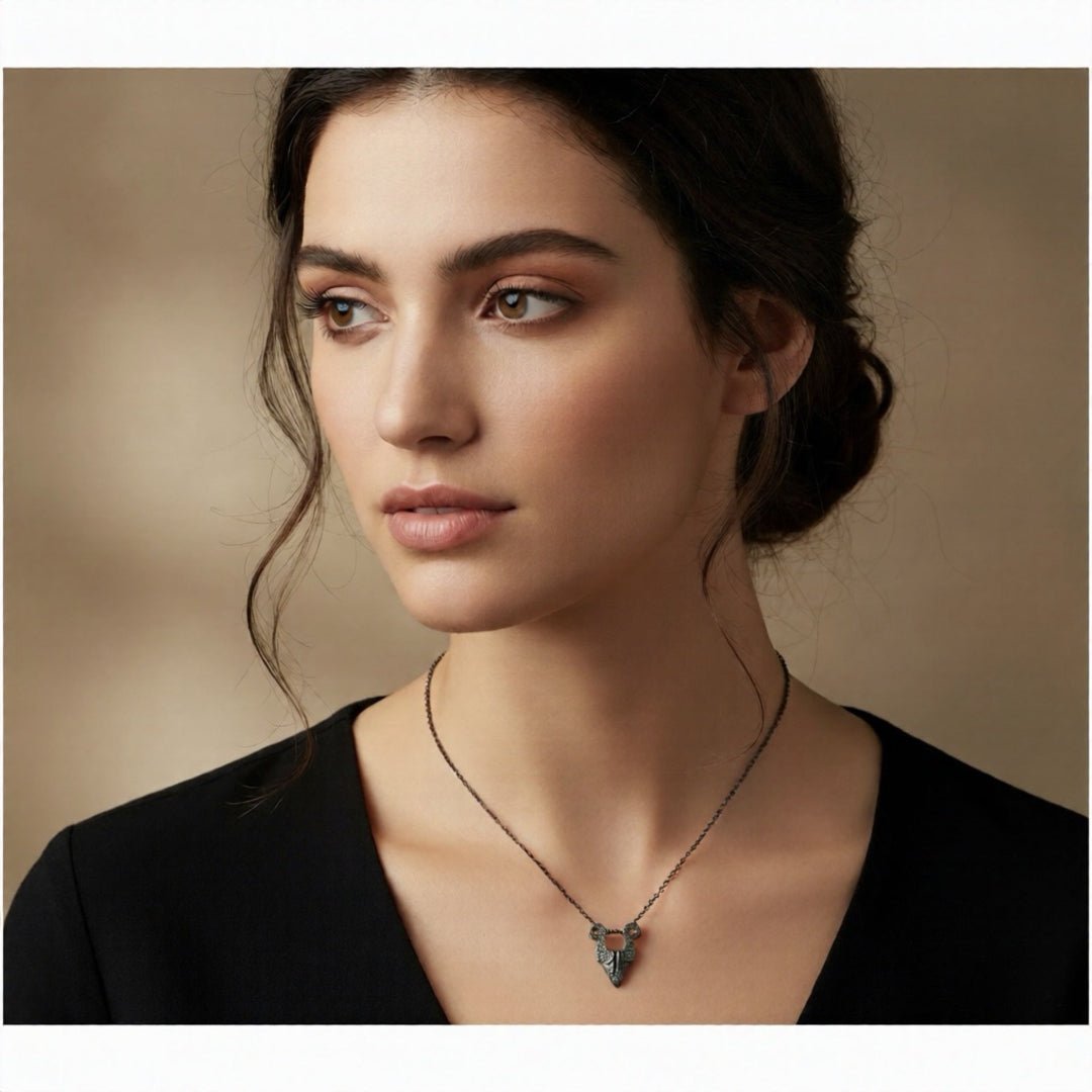 Woman wearing a necklace with a pendant against a neutral background