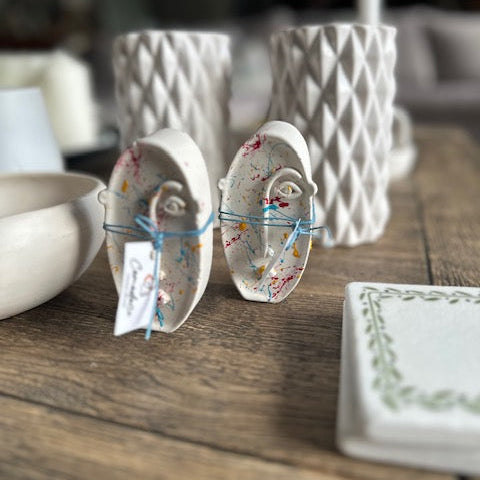 Decorative ceramic items on a wooden surface with a blurred background