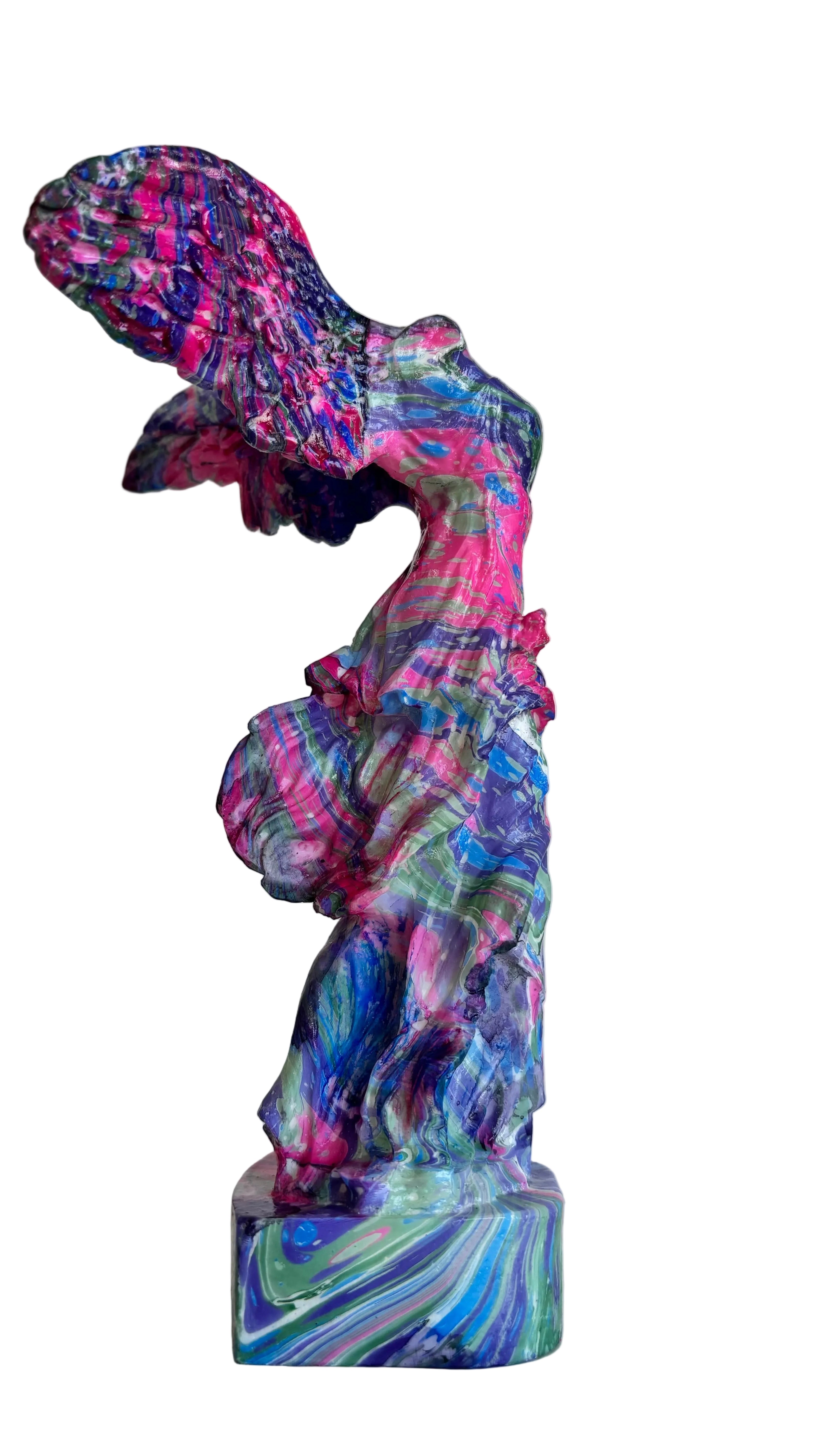 Colorful abstract sculpture on a white surface with a light gray background