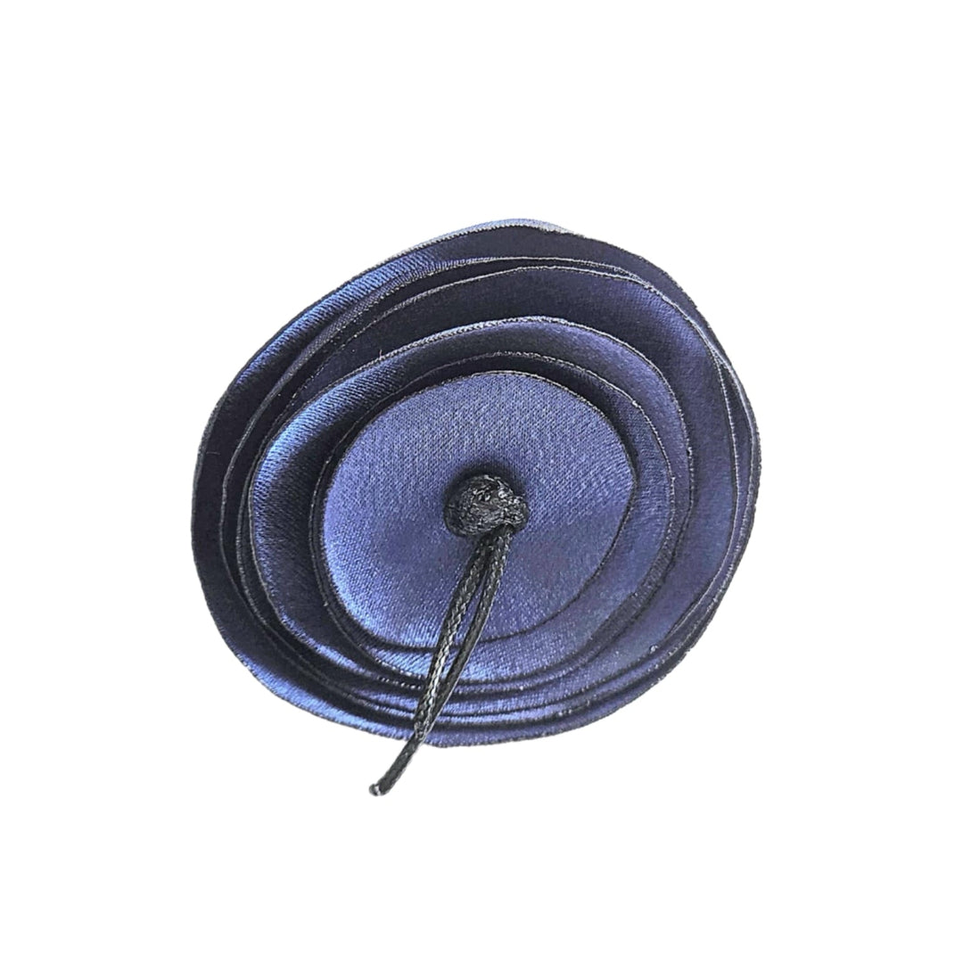 Blue circular object with a string on a white background