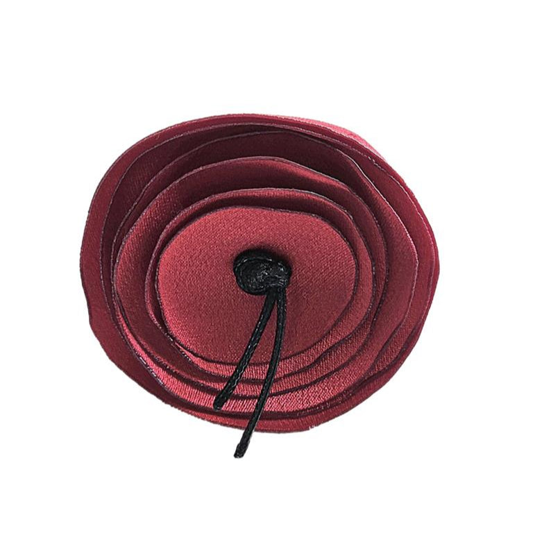 Red flower-shaped hair clip on a white background