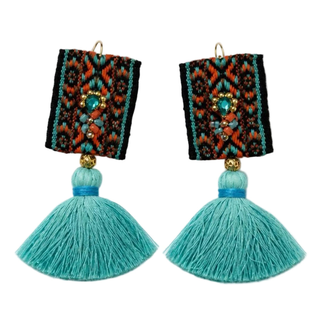 A pair of bohemian-style drop earrings featuring rectangular black woven panels with colorful geometric patterns in red, orange, and turquoise, hanging from gold hooks with large turquoise tassels below.