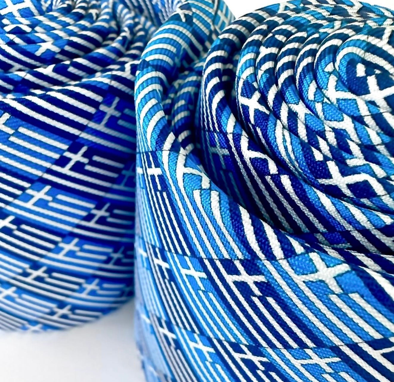 Close-up of blue and white patterned fabric rolls