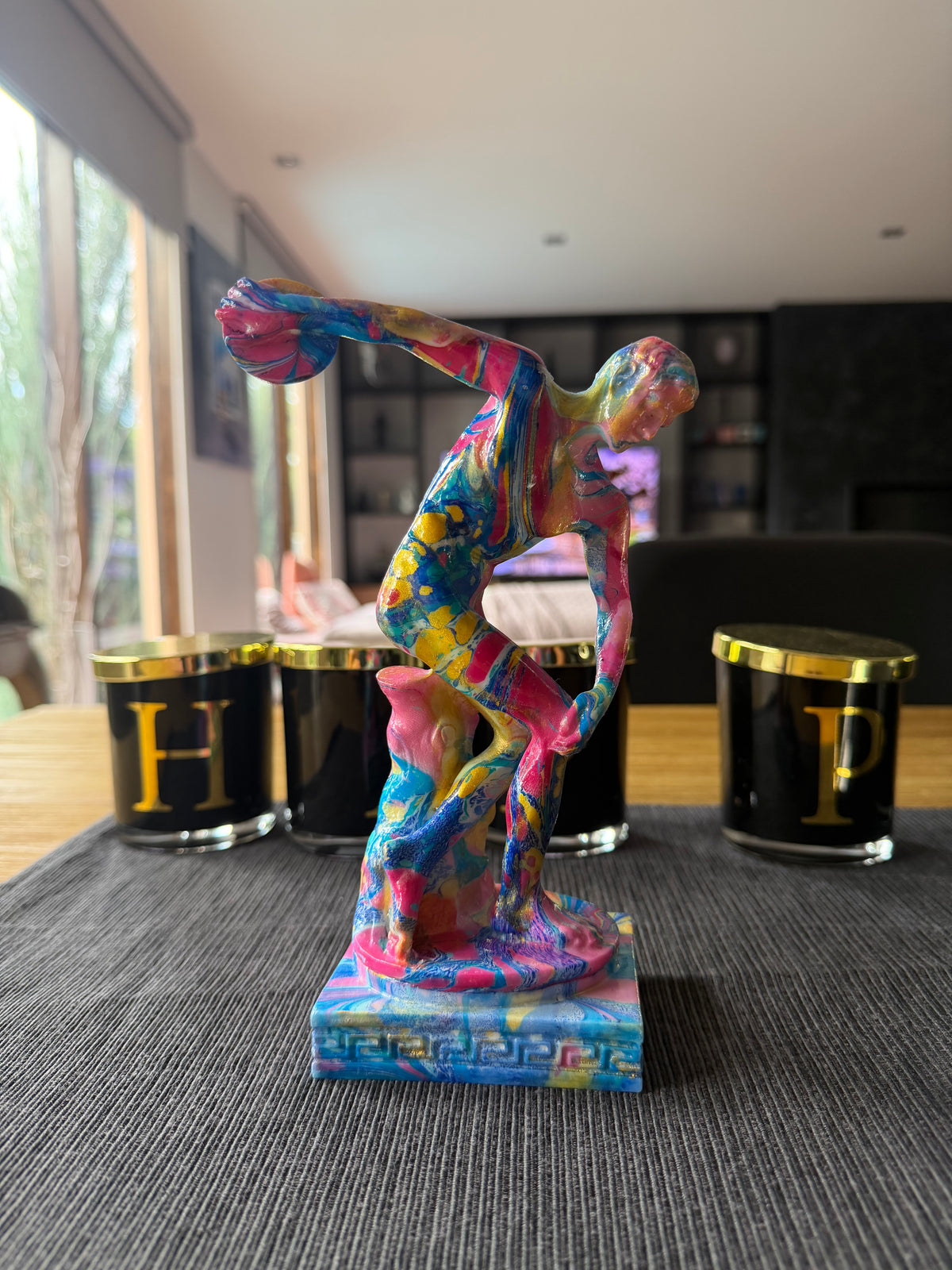 Colorful abstract sculpture on a stand in an indoor setting