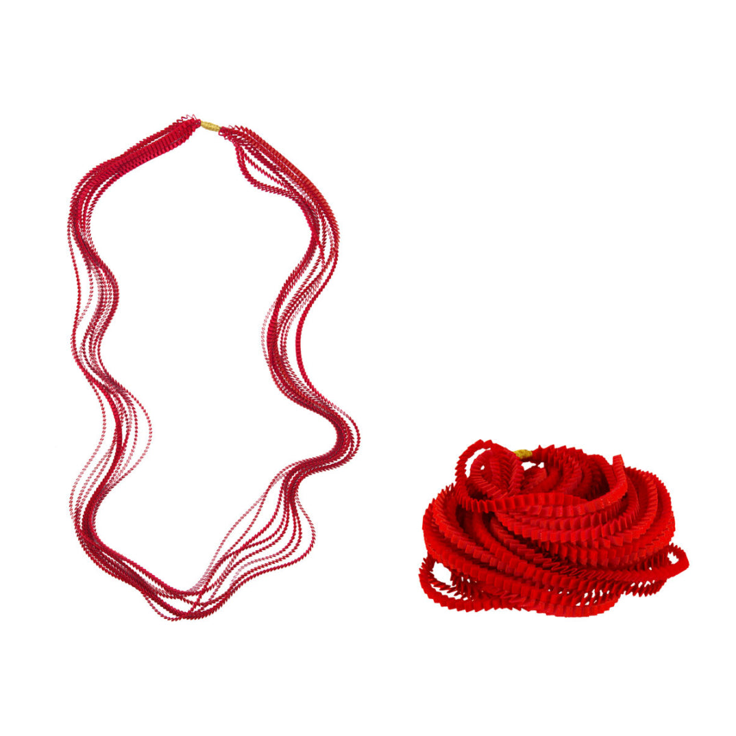 Red necklace and its packaging on a white background