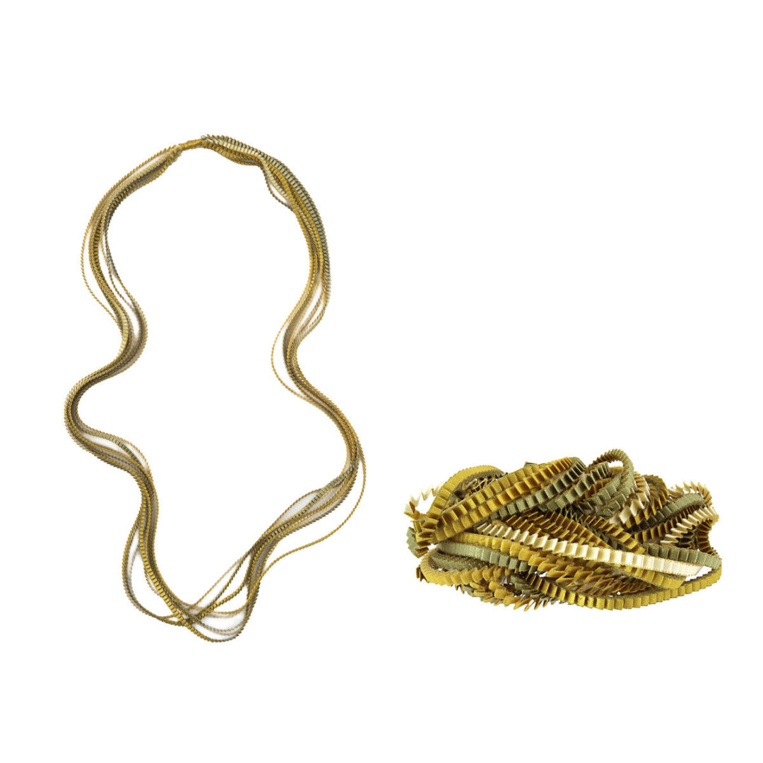 Gold necklace with a clump of gold coins on a white background