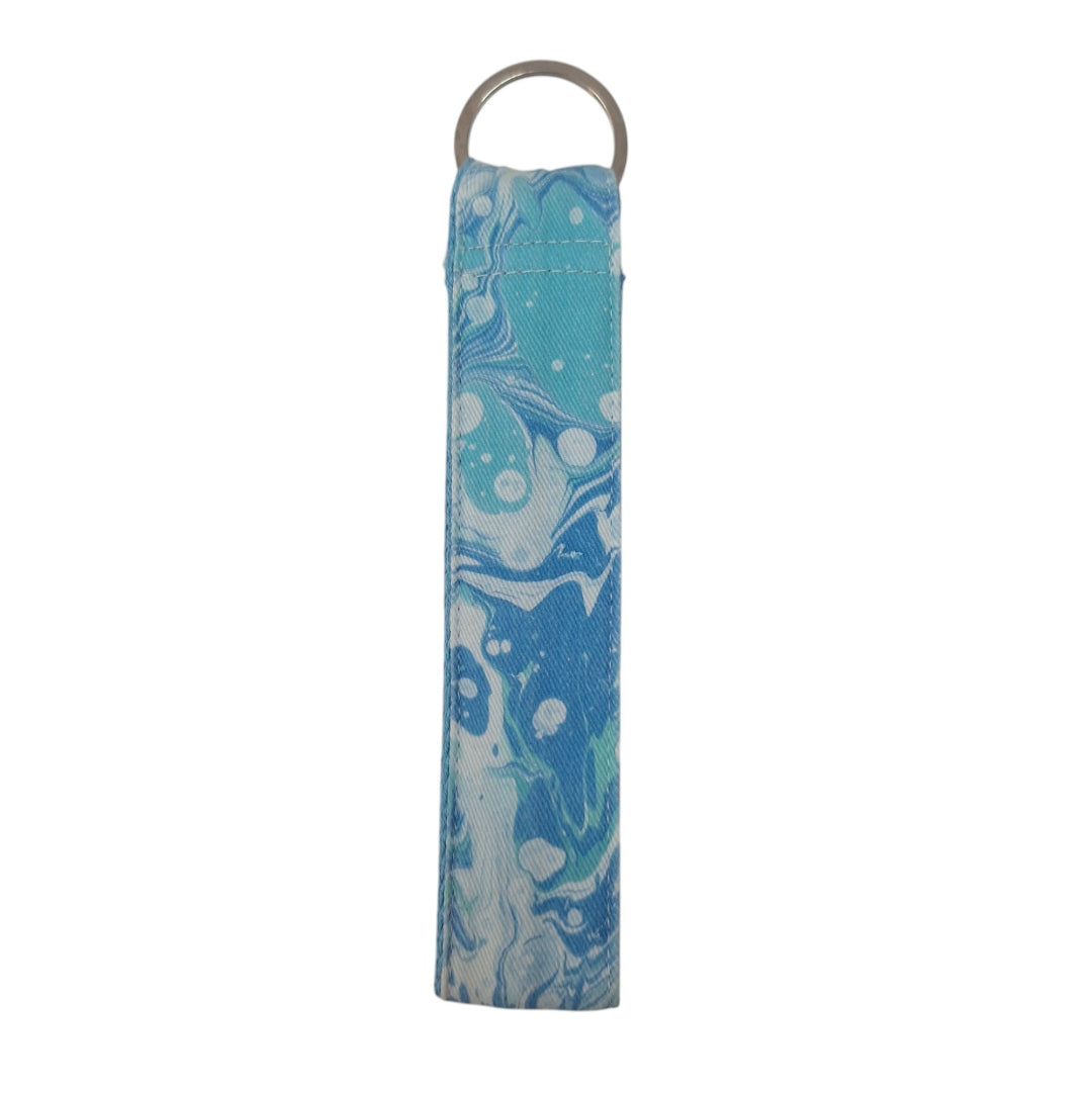 Blue marbled keychain with a metal ring on a white background