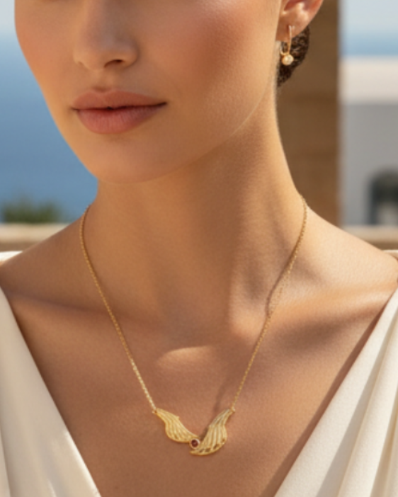 Woman wearing a gold necklace with a blurred outdoor background