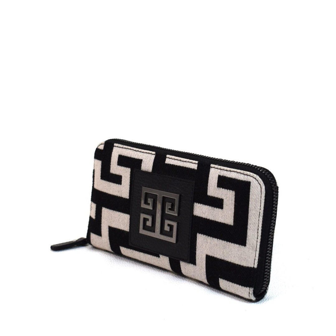 A wallet with a geometric pattern in black and ecru colors, featuring genuine leather details and a zipper closure.