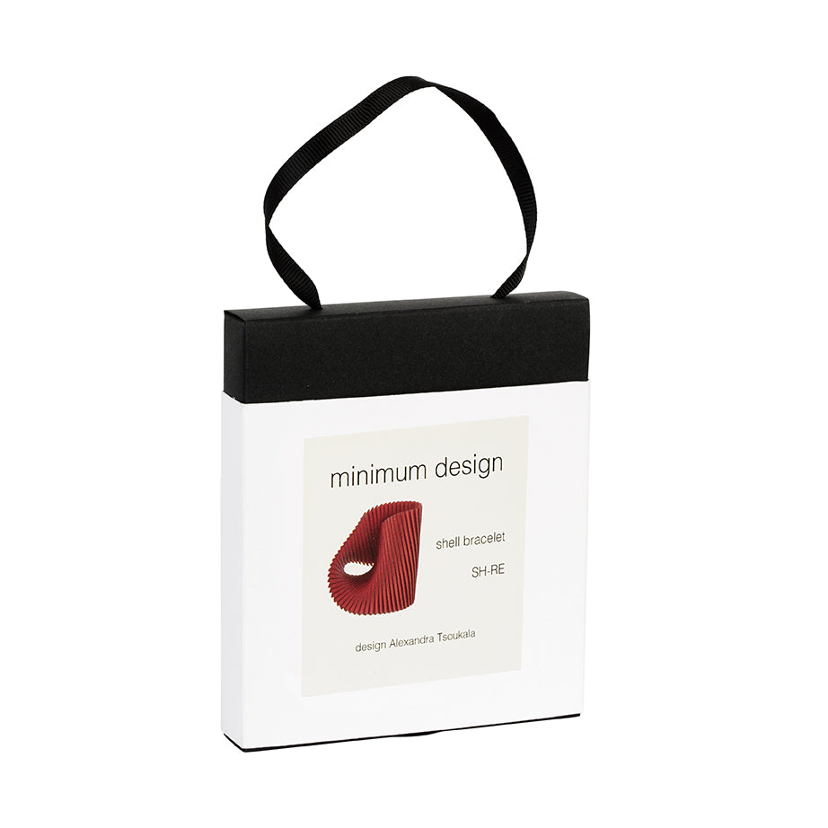 White packaging box with black handle featuring 'minimum design' branding and a red lip graphic.