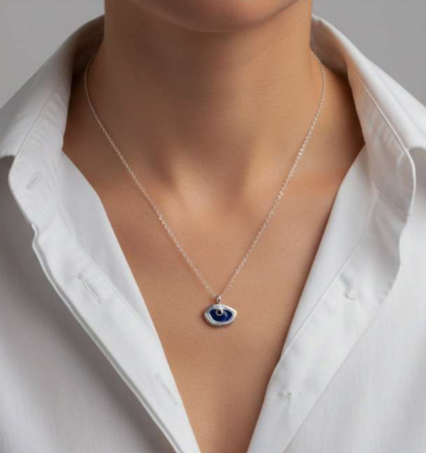 Necklace with a blue eye pendant on a mannequin wearing a white shirt.