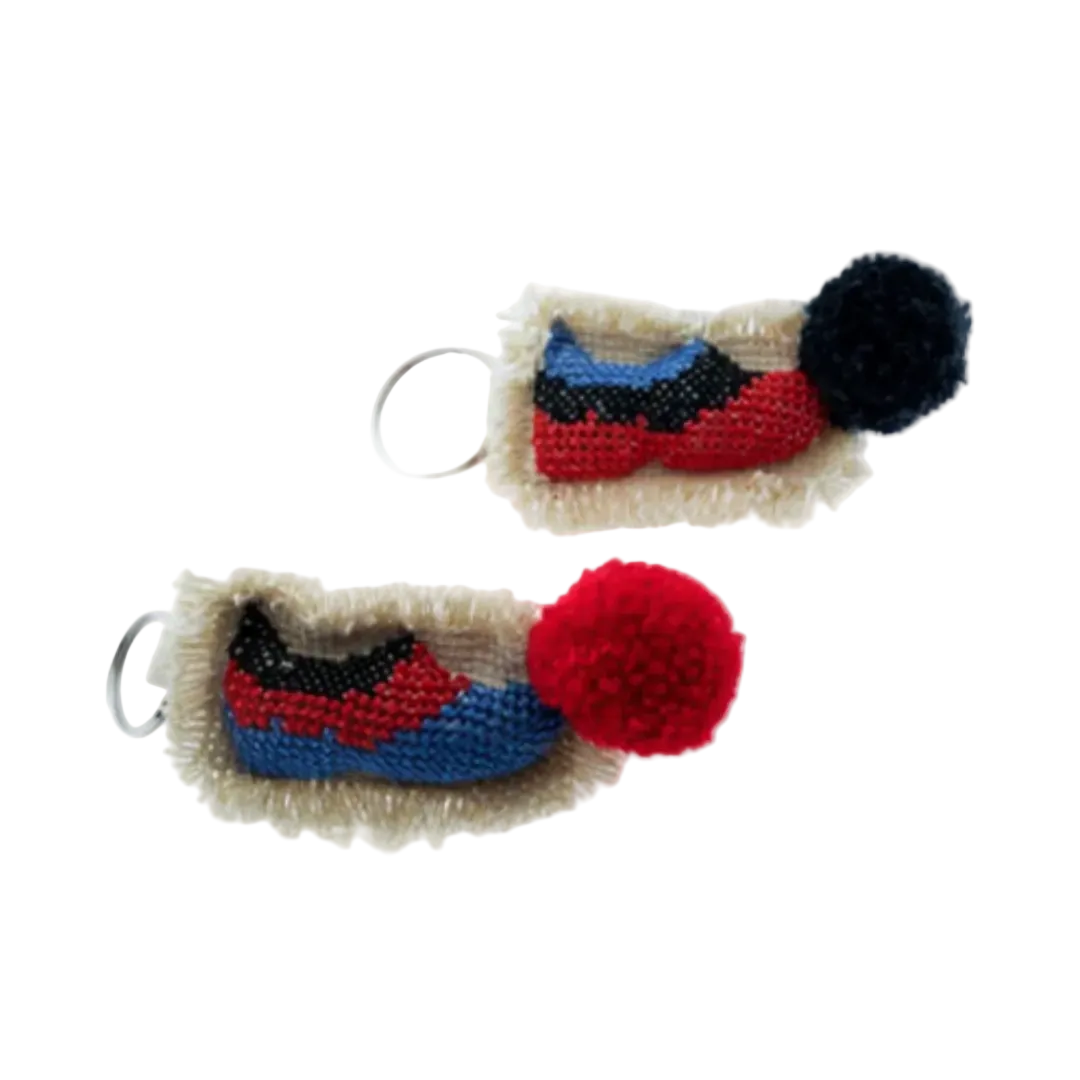 Two colorful keychains with pom-poms on a white background