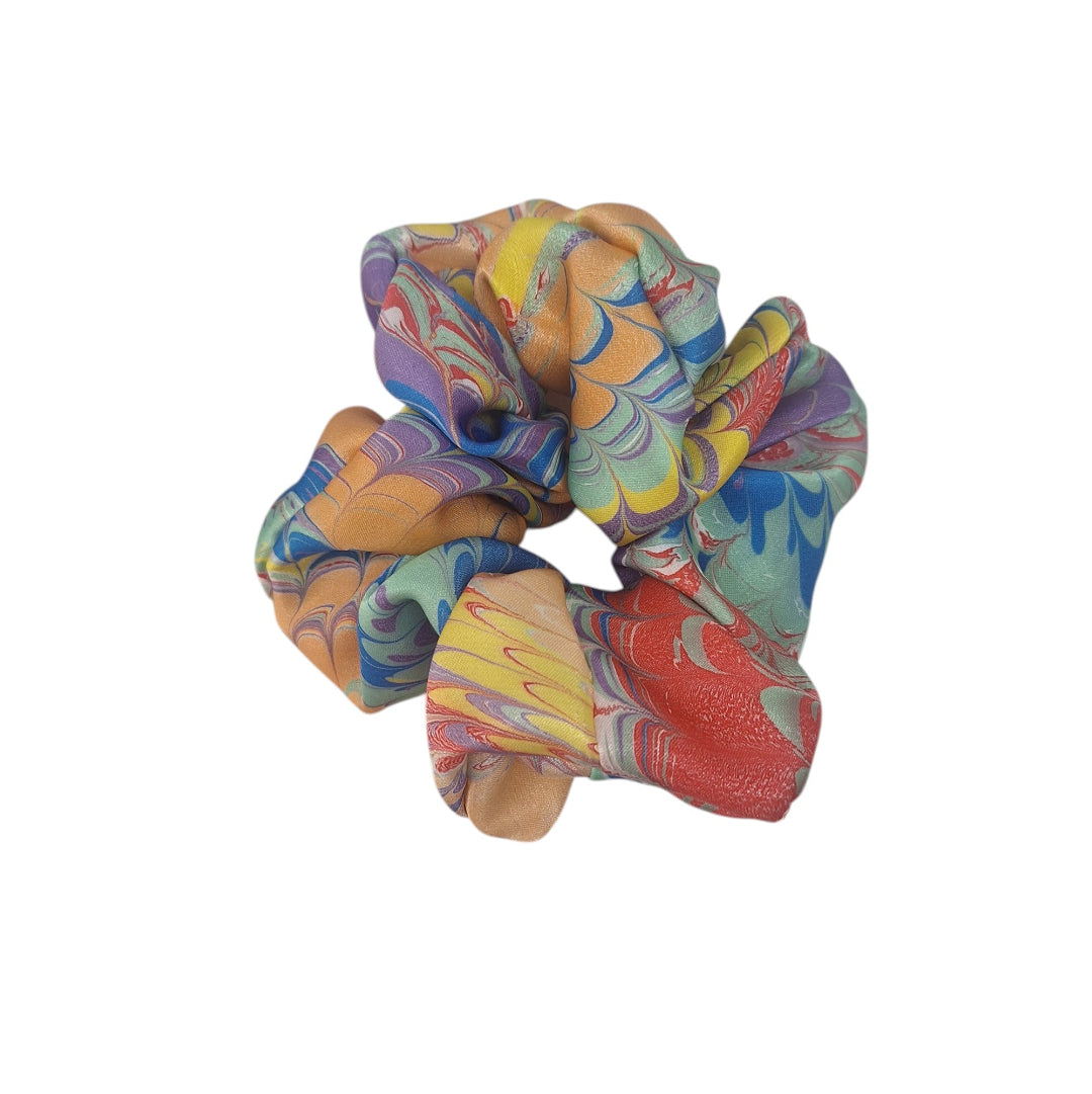 Colorful scrunchie with a tie-dye pattern on a white background