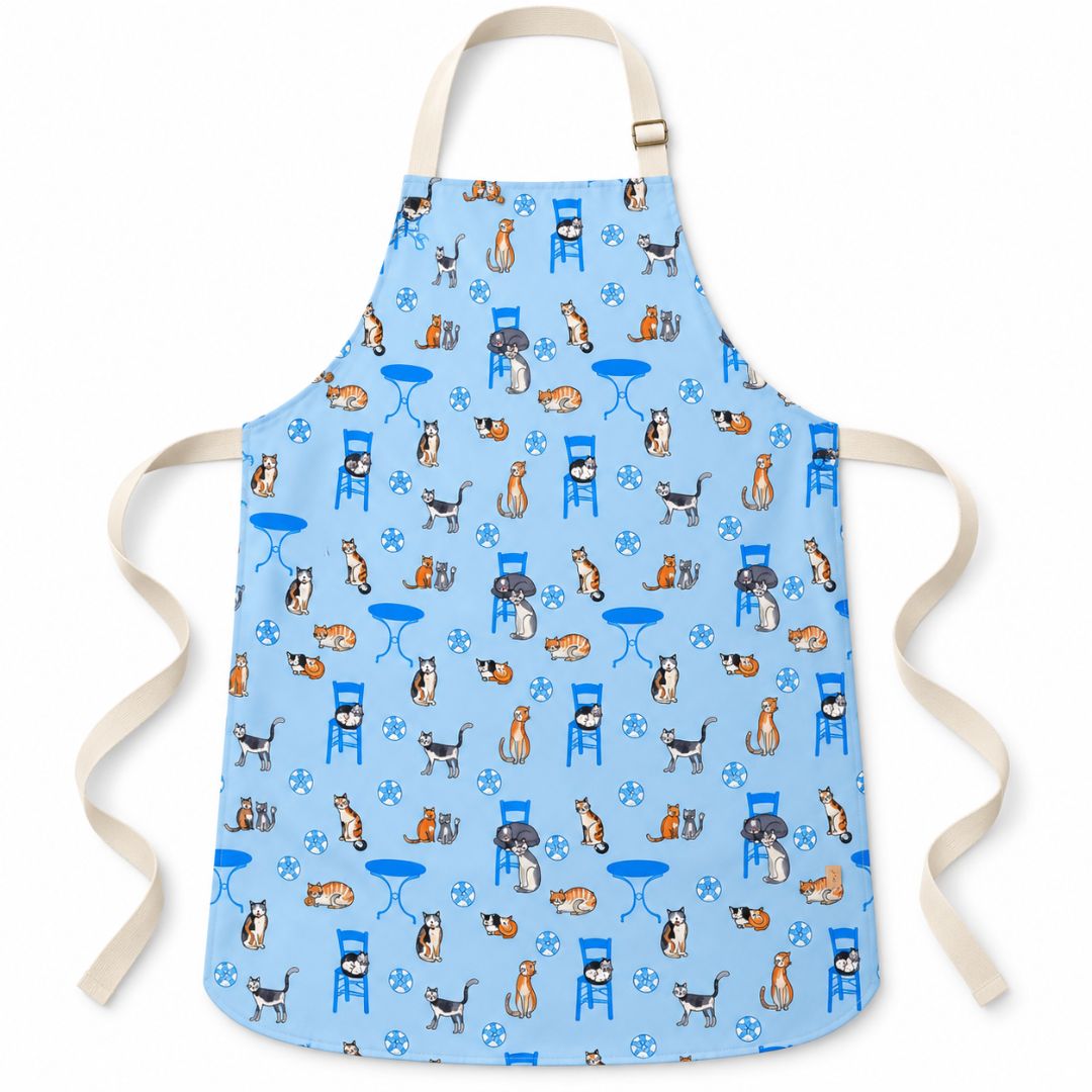 Greek Island Cats Apron – water-resistant apron with Greek cats, blue chairs and café tables on soft blue, front view | Thalassea