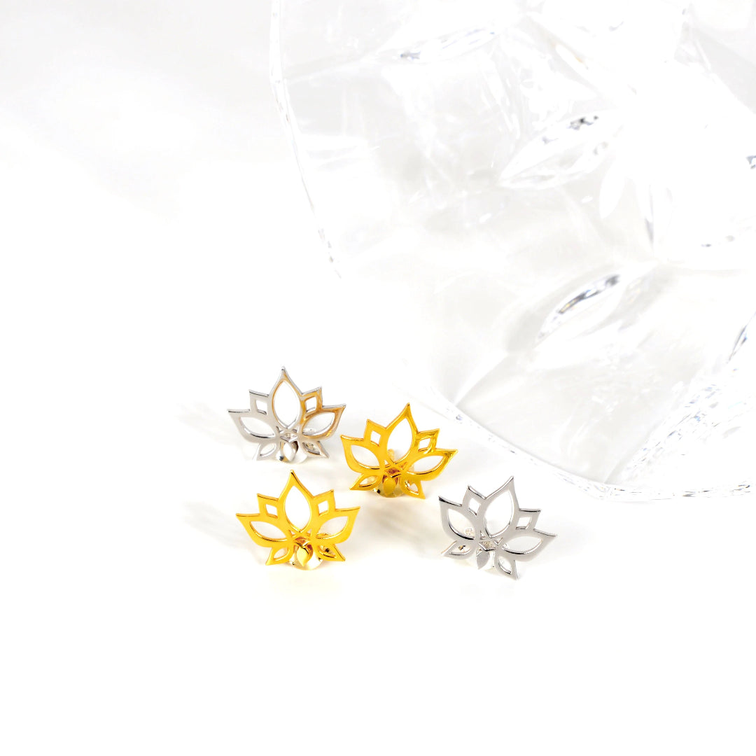 Lotus flower earrings in gold, silver, and yellow on a white background