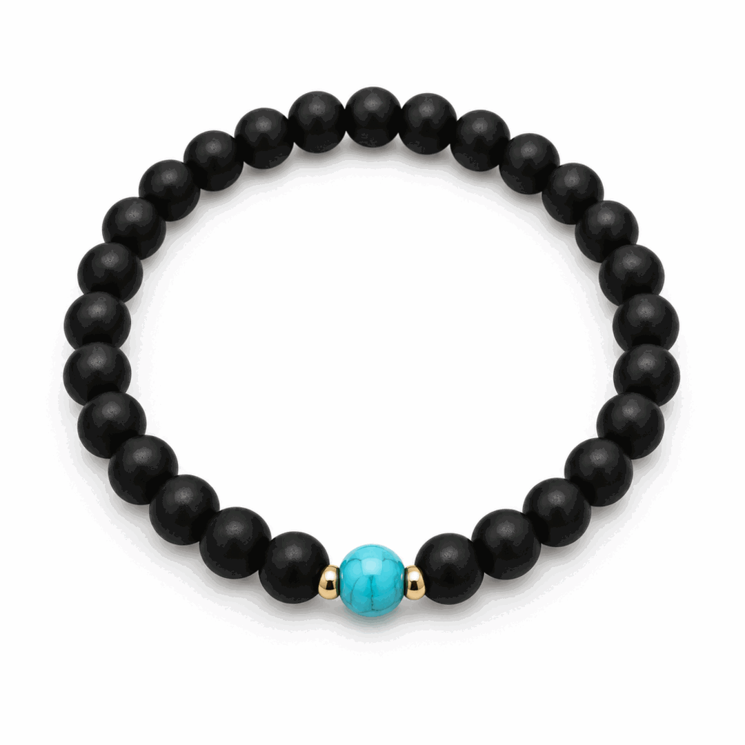A beaded stretch bracelet featuring matte black round beads, a central turquoise blue bead, and small gold spacer beads, shown on a clean white background.