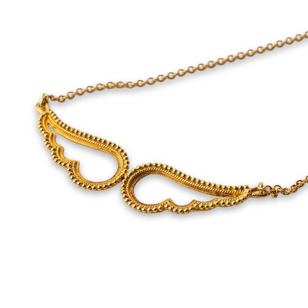 An 18K gold pendant in the shape of angel wings attached to a gold chain.
