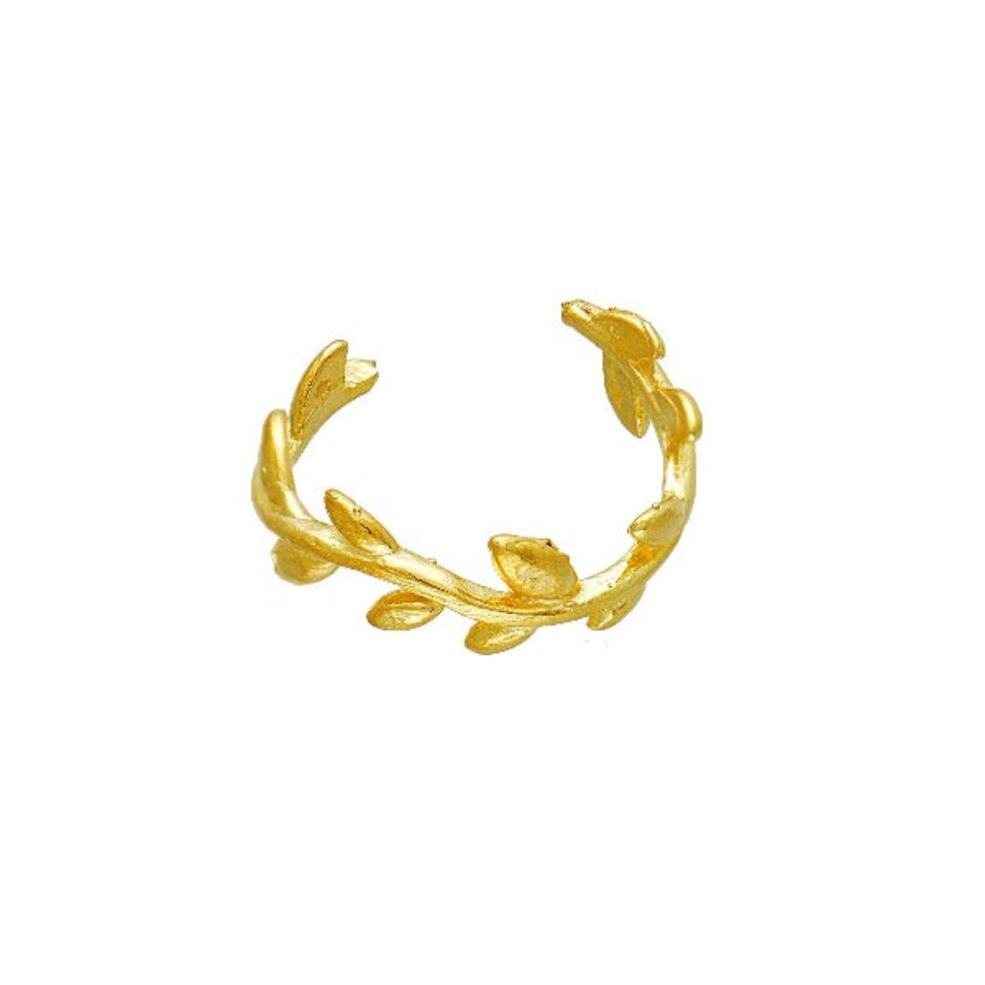 A gold-plated ear cuff with leaf patterns.