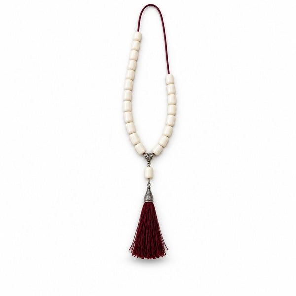 Ivory beaded strand with burgundy tassel