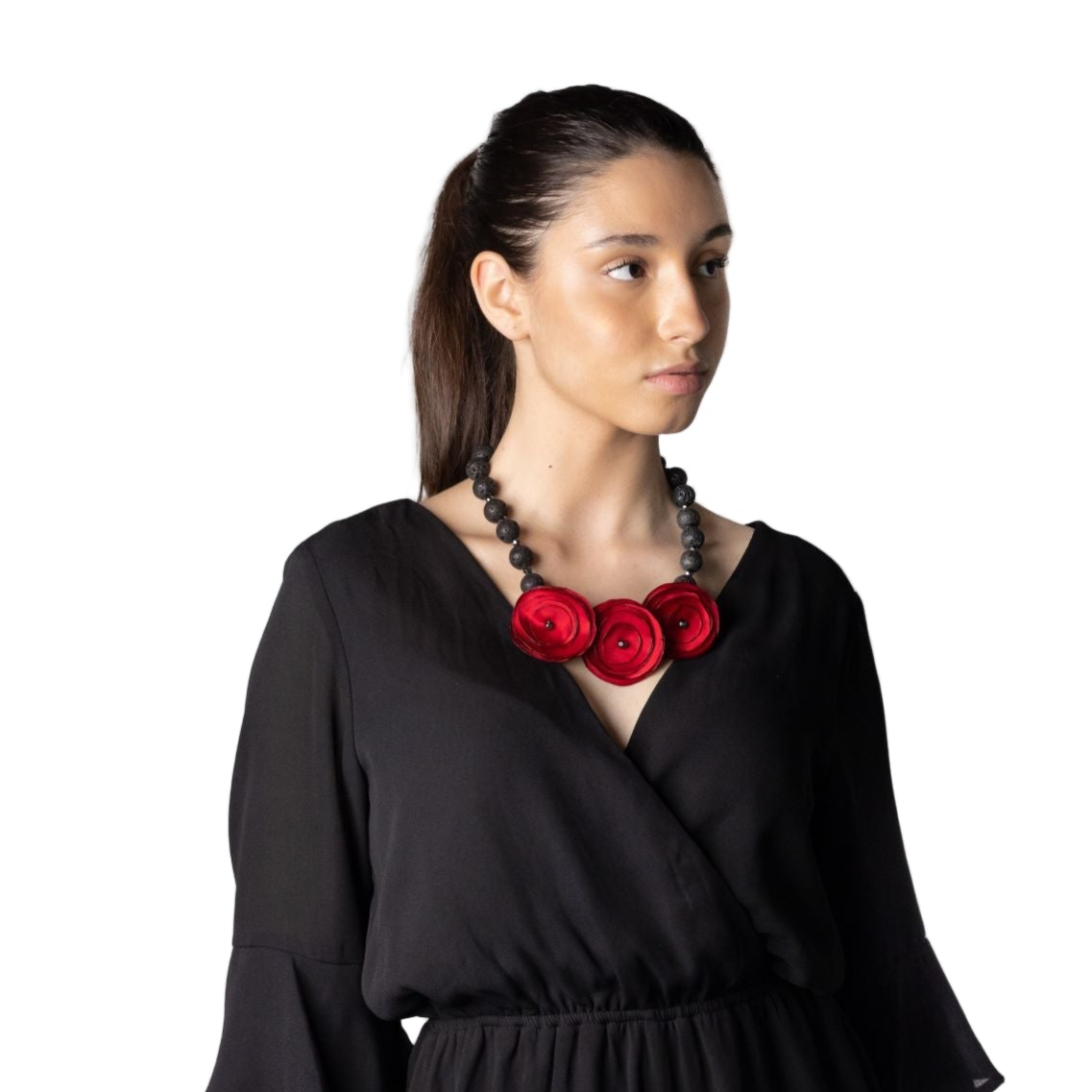Woman wearing a black dress with a red floral necklace on a white background
