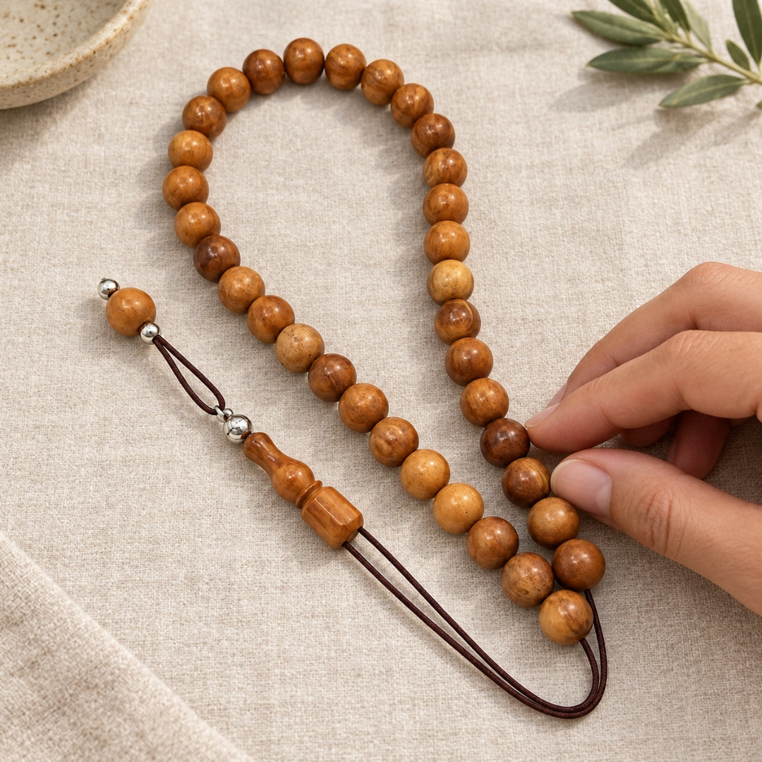 Hand touching round wooden beads