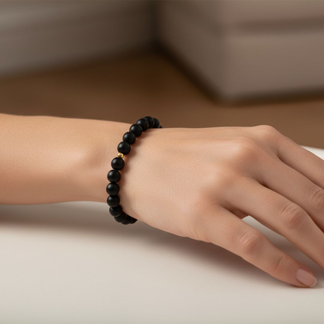 Woman wearing black bead bracelet