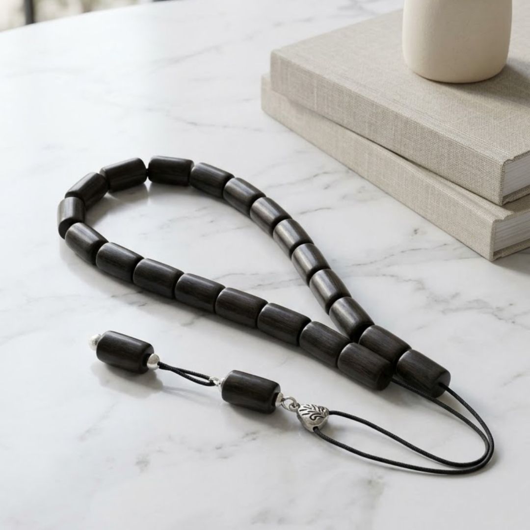 Black beaded strand beside books
