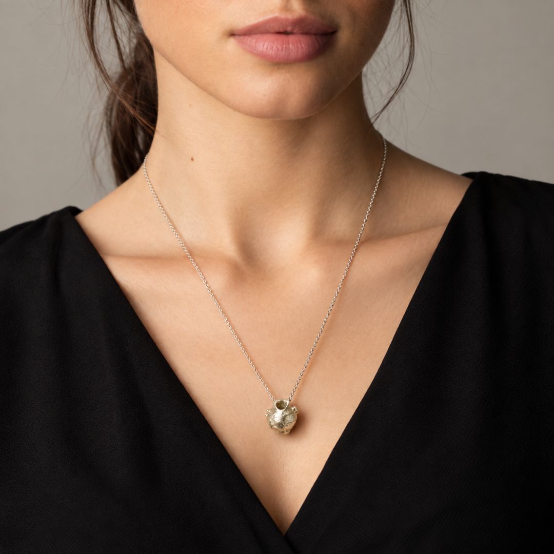 Woman wearing Greek pendant necklace