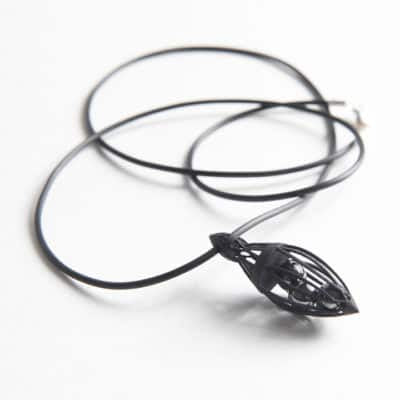Black leaf-shaped pendant on a white background