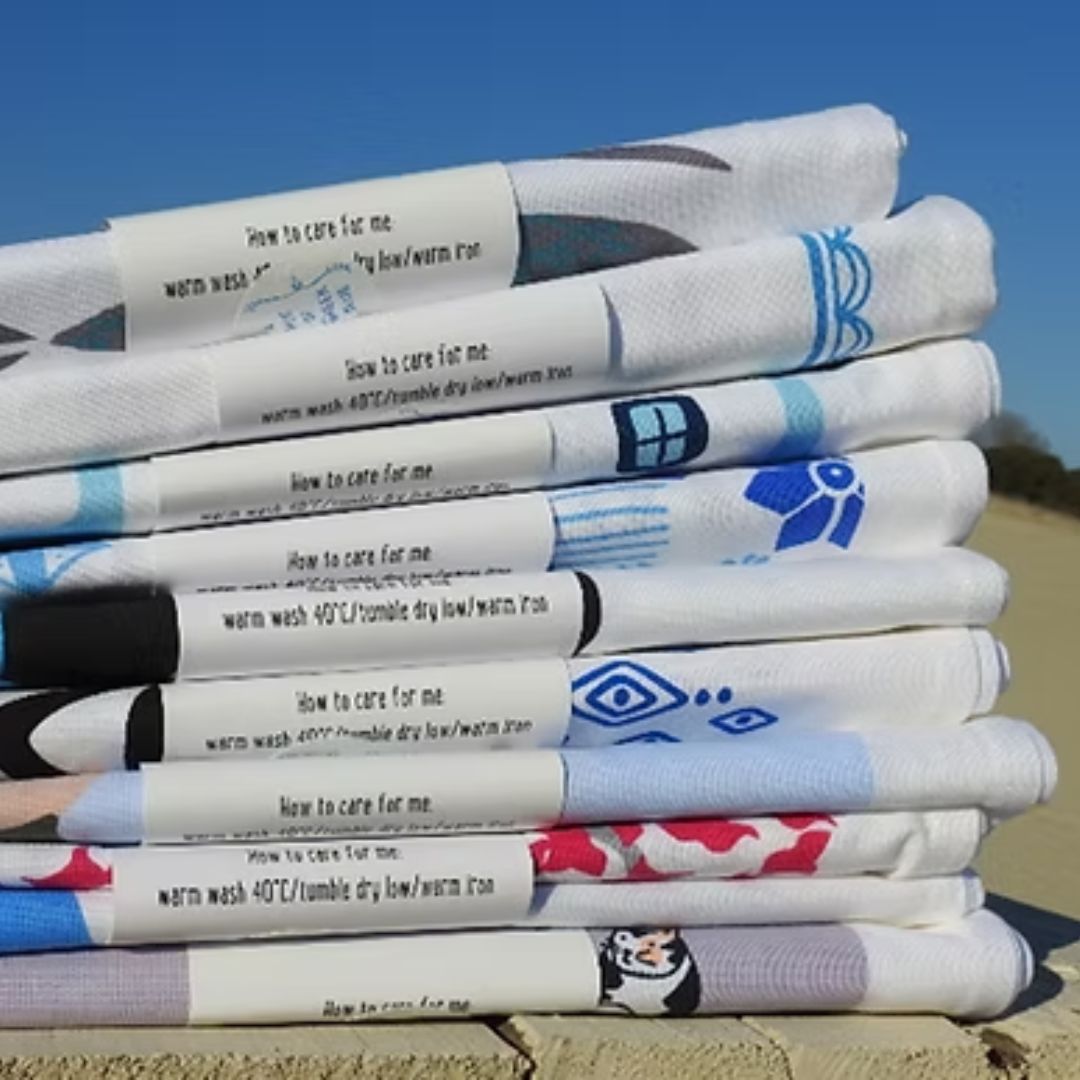 Stacked A Hue of Greek Blue cotton tea towels in paper wrap, styled | Thalassea