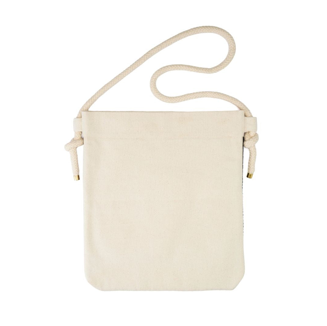 A small off-white canvas crossbody bag with a matching rope strap and drawstring ties, shown against a plain white background.