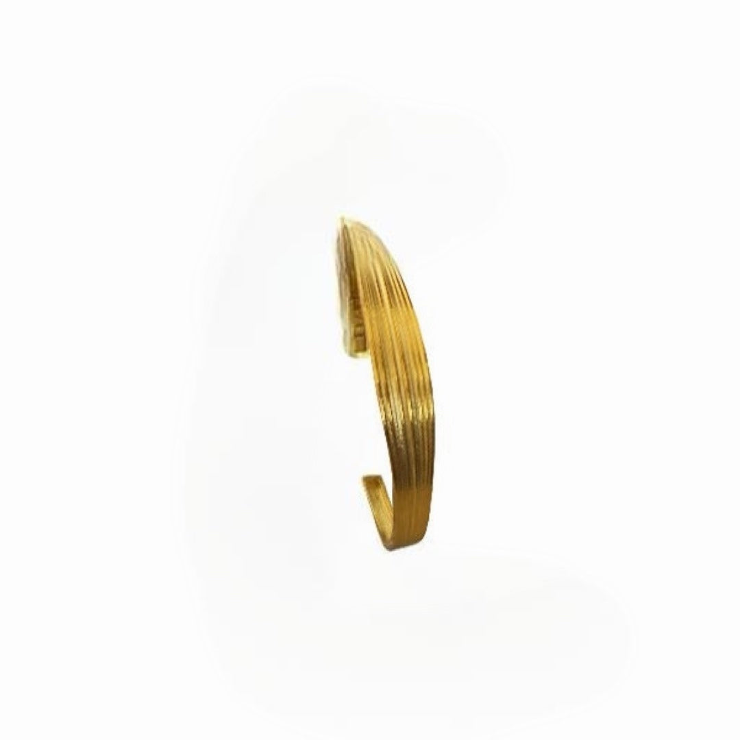 Gold bangle on a white background