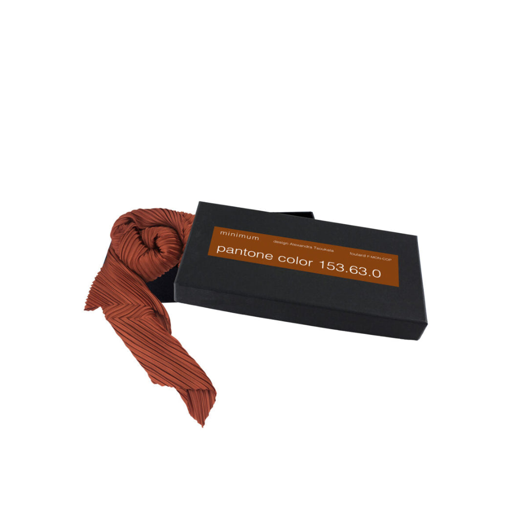 Brown scarf with packaging labeled 'pantone color 153.63.0' on a white background